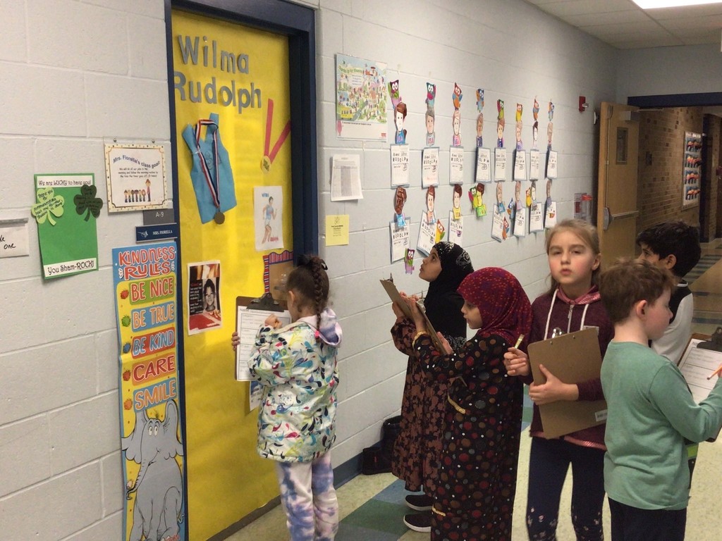 Ms. Frey's class on a gallery walk of doors decorated for Women's History Month. #IGAchieves