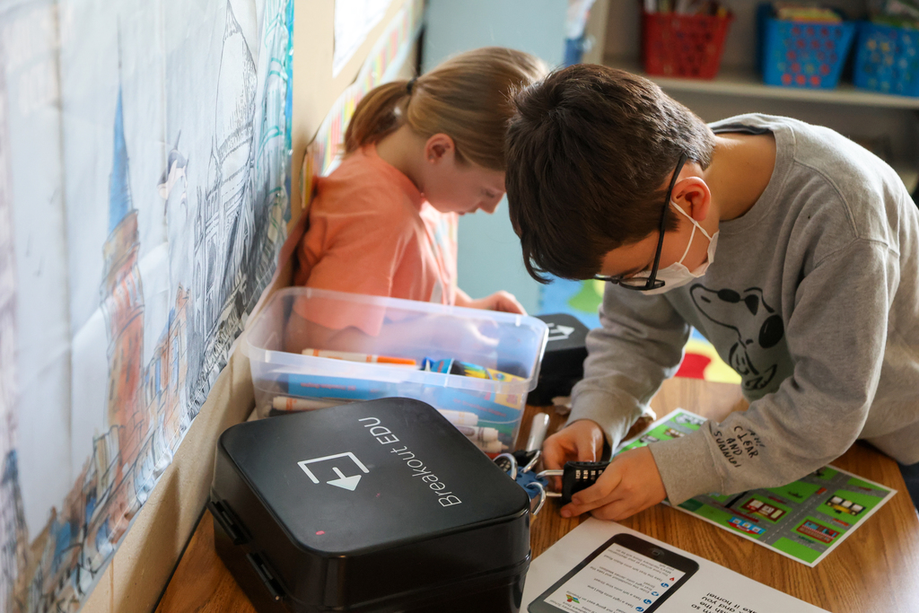 student trying to unlock a breakout box