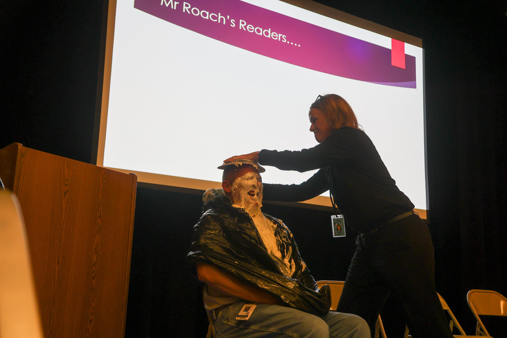 Mrs. Grow putting pie in Mr. Roach's face