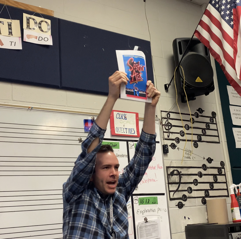 Mr. L-T holding up the spring musical choice