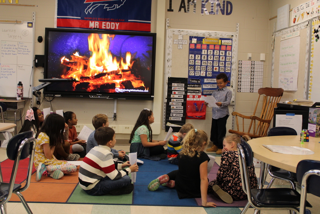 student presenting his story to the class. 
