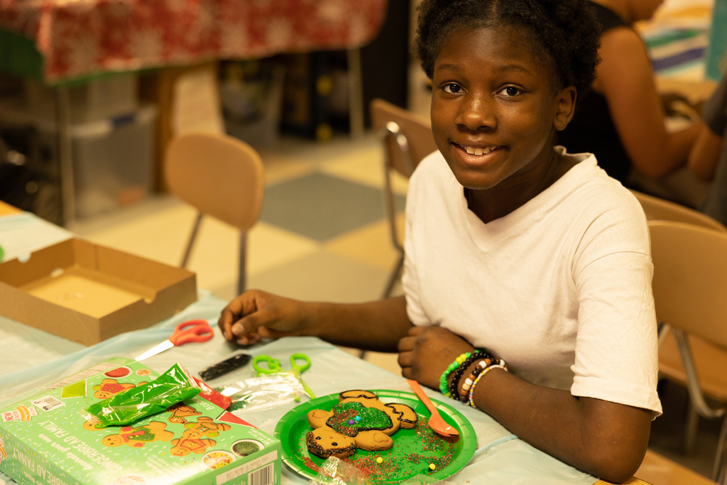 student decorating a gingerbread cookie