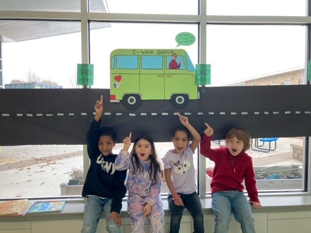 Students pointing to the I-van Green reading progess