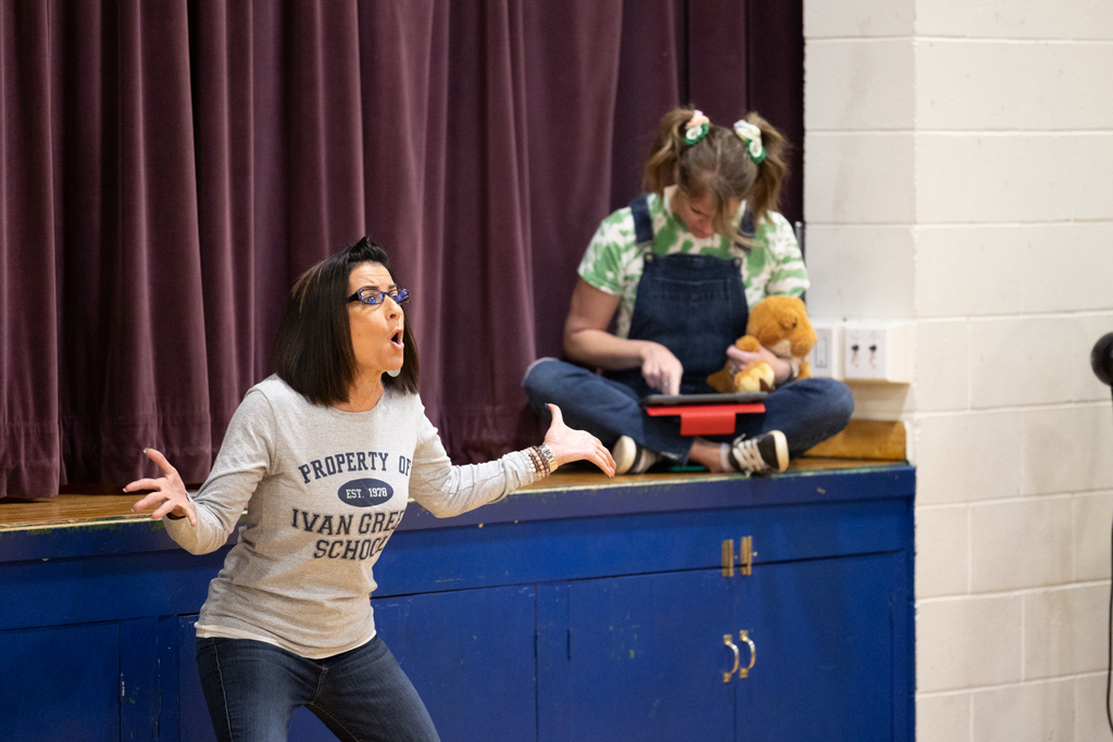 Staff acting in a play