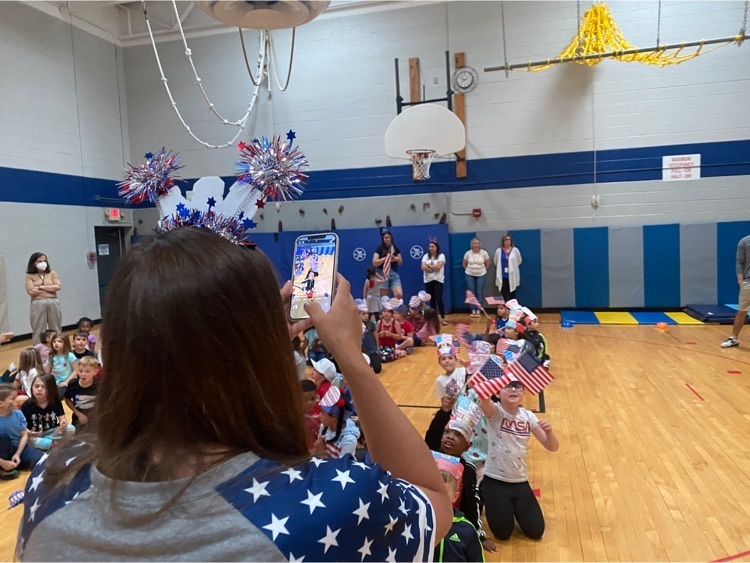 teacher taking pictures of students