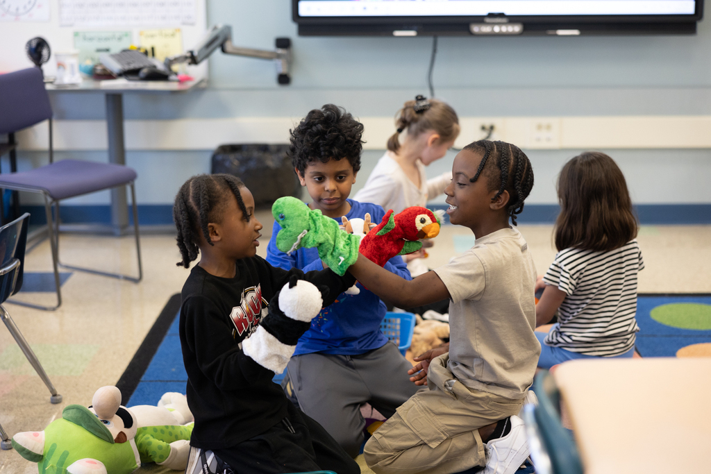2nd graders playing with puppets