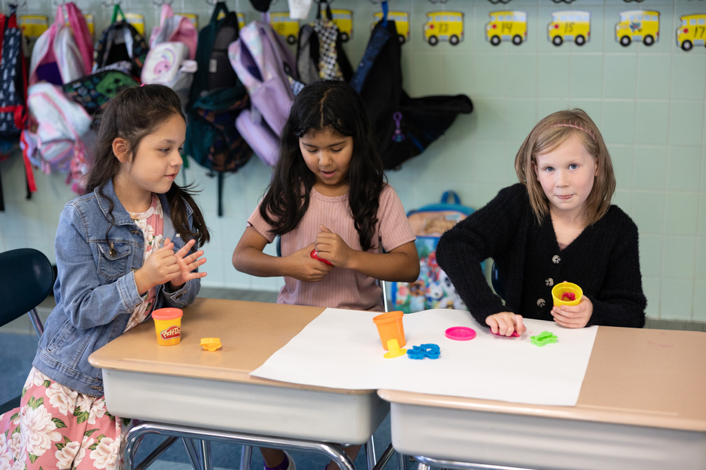 2nd graders playing with play dough